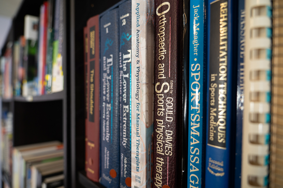 Bookshelf of massage and anatomy books