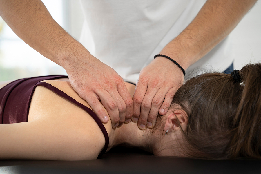 Close up of hands massaging neck